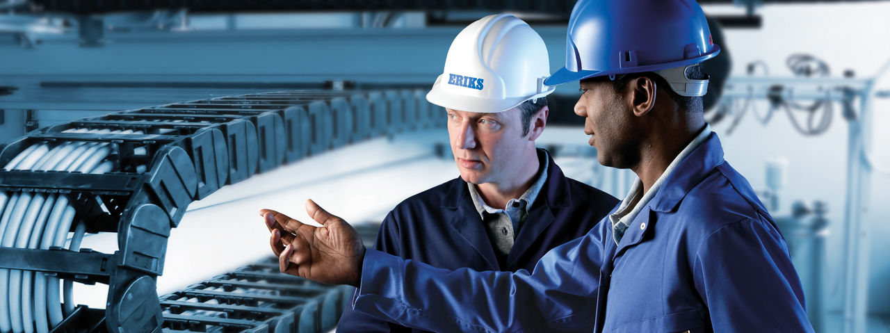 two man sitting and typing on computers